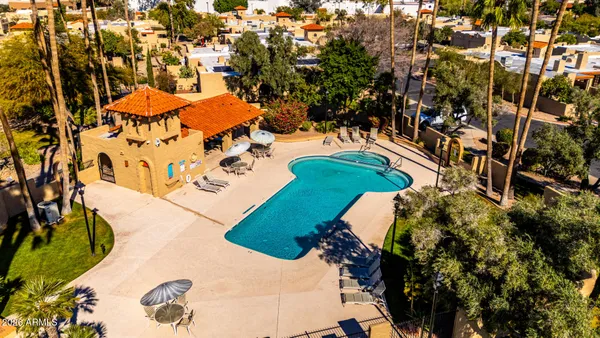 an aerial view of a house a yard and mountain view in back