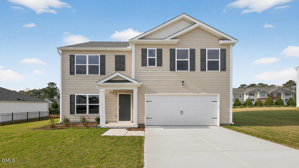 a front view of a house with a yard and garage