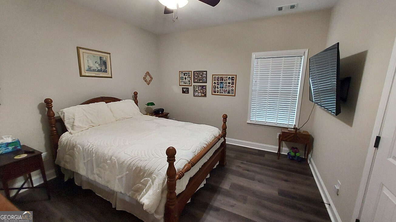 107 Lighterknot Trail Perry, GA 31069 - Photo 15 of 22 a bedroom with a bed and a flat tv screen on a dresser