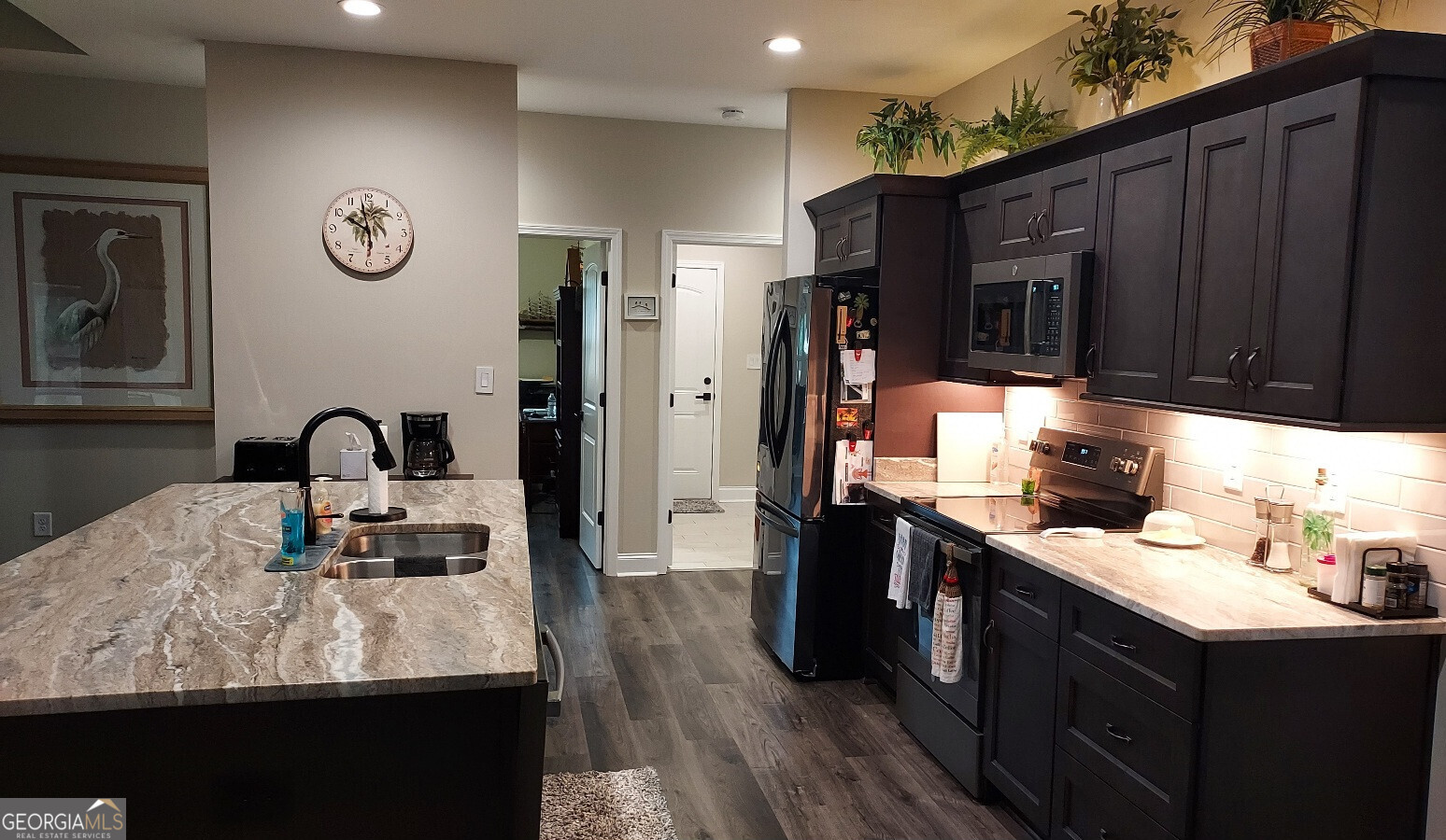 107 Lighterknot Trail Perry, GA 31069 - Photo 7 of 22 a kitchen with granite countertop a sink cabinets and wooden floor