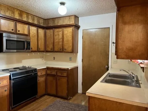 a kitchen that has a sink and a stove in it