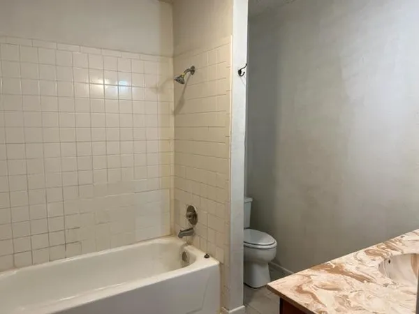 a bathroom with a bathtub and toilet