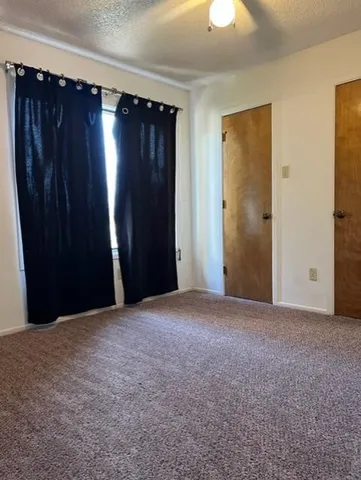 a view of empty room with a ceiling fan