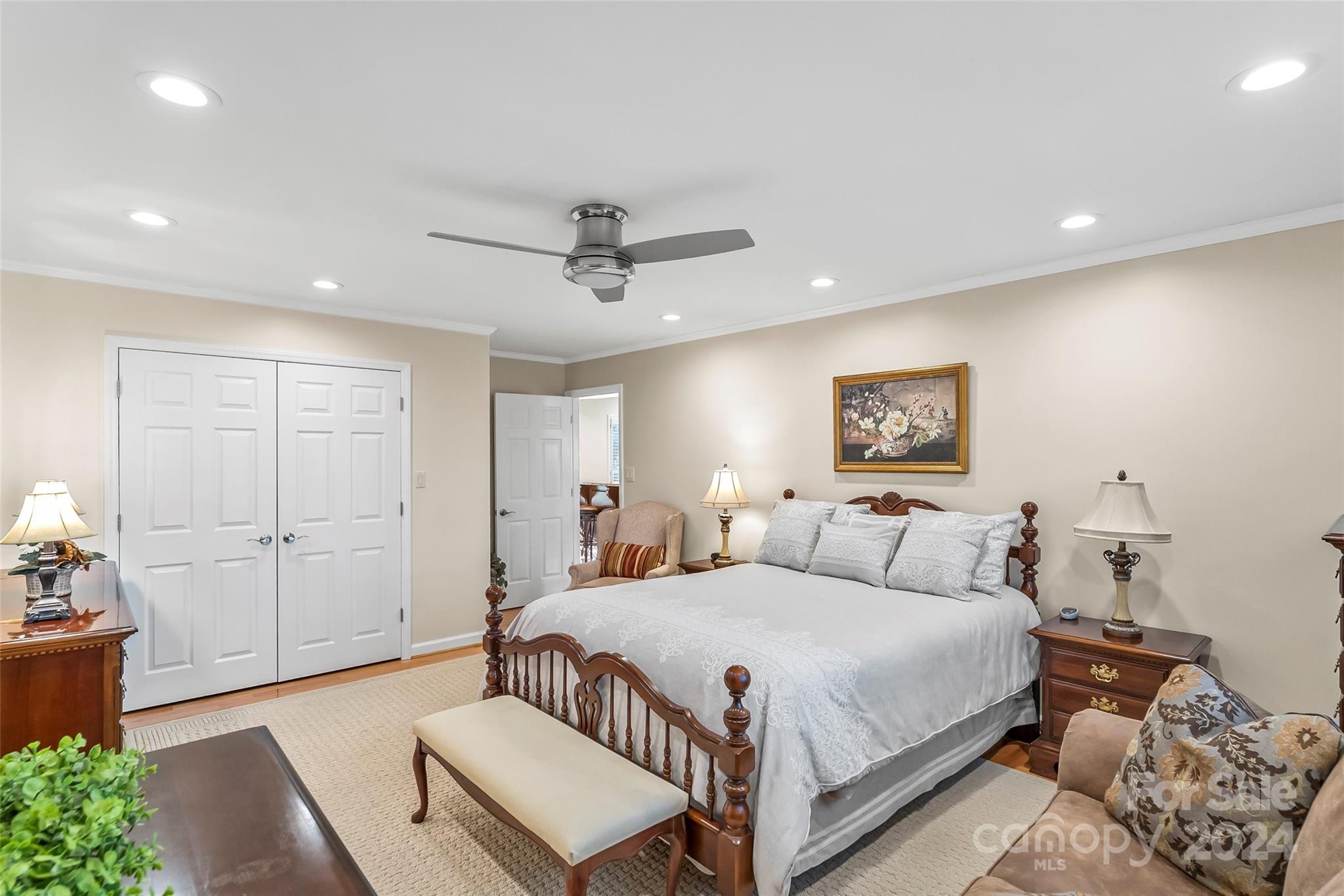 203 Lost Corner Road Morganton, NC 28655 - Photo 24 of 47 a bedroom with a large bed and a chandelier