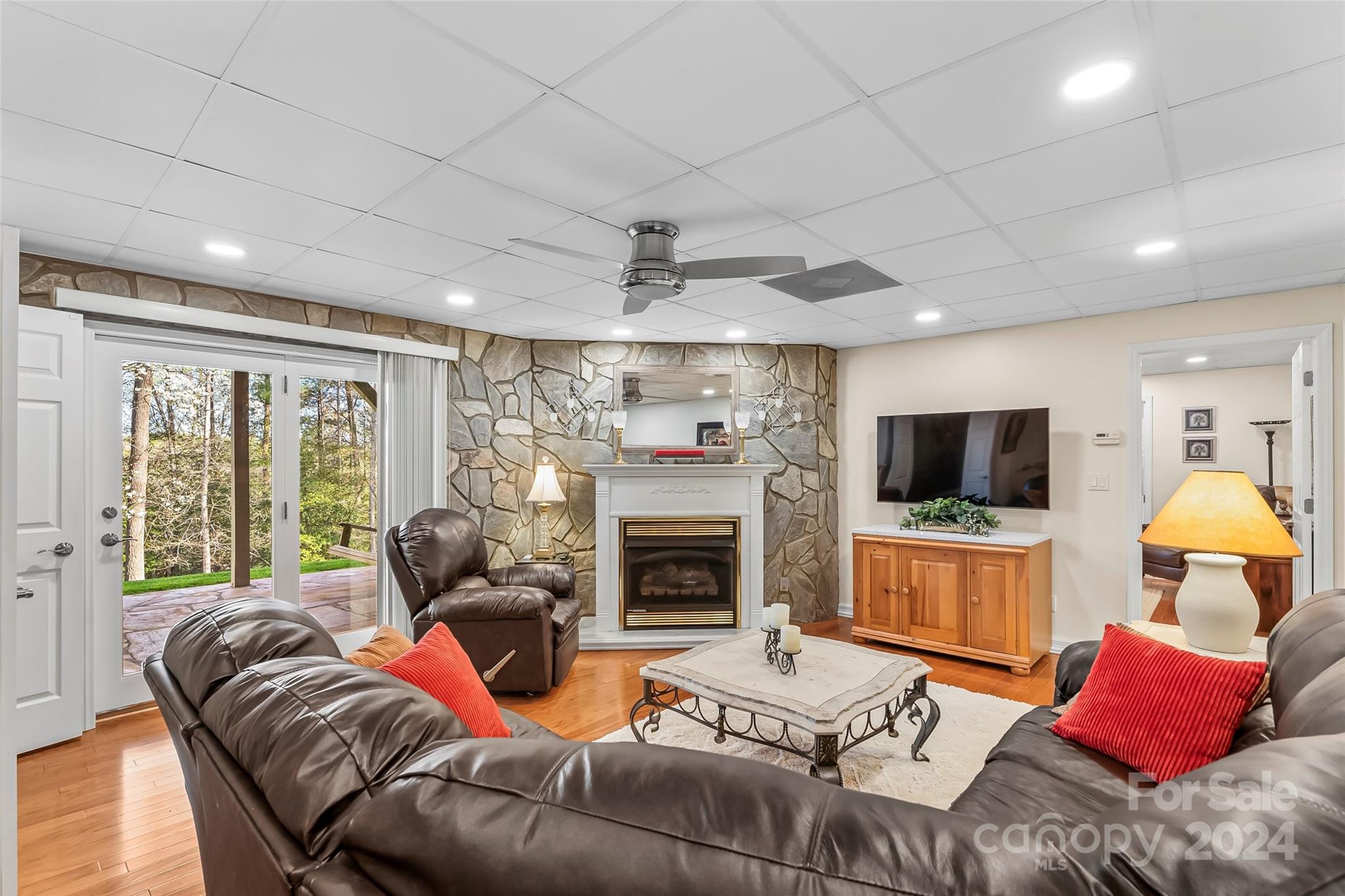 203 Lost Corner Road Morganton, NC 28655 - Photo 27 of 47 a living room with furniture a fireplace and a flat screen tv