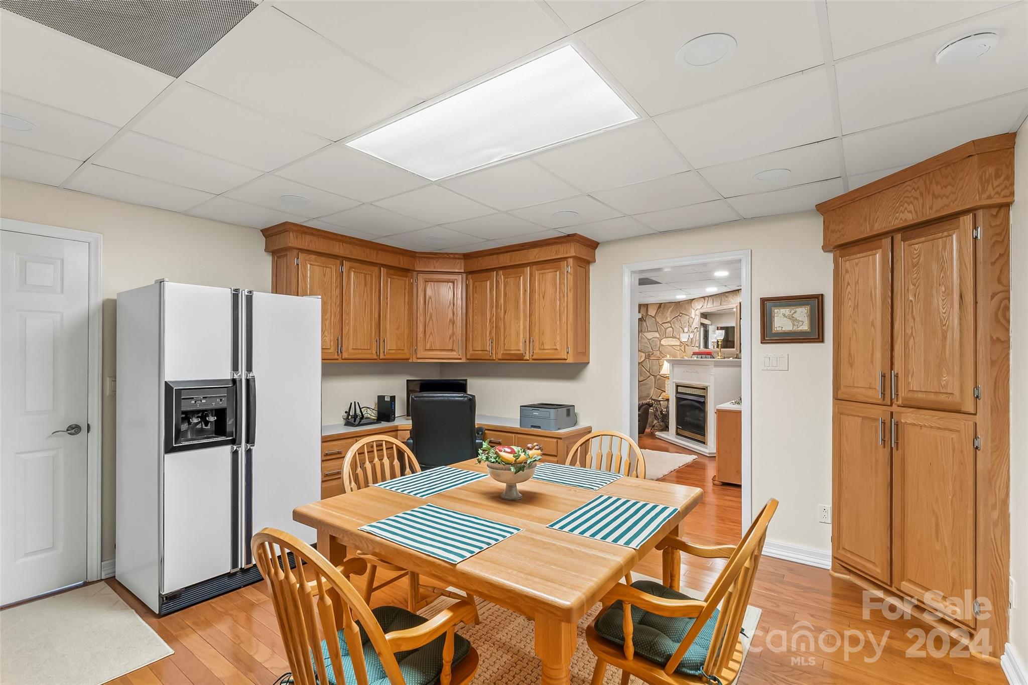 203 Lost Corner Road Morganton, NC 28655 - Photo 31 of 47 a kitchen with stainless steel appliances a refrigerator a stove a sink dishwasher a dining table and chairs with wooden floor