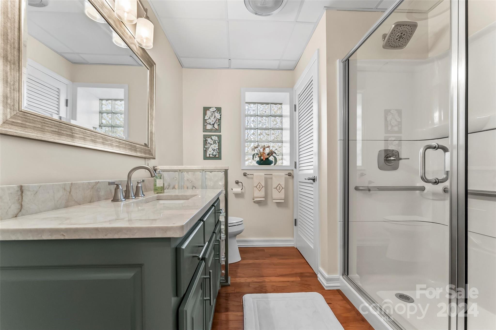 203 Lost Corner Road Morganton, NC 28655 - Photo 34 of 47 a en suite bathroom with a granite countertop sink mirror and shower