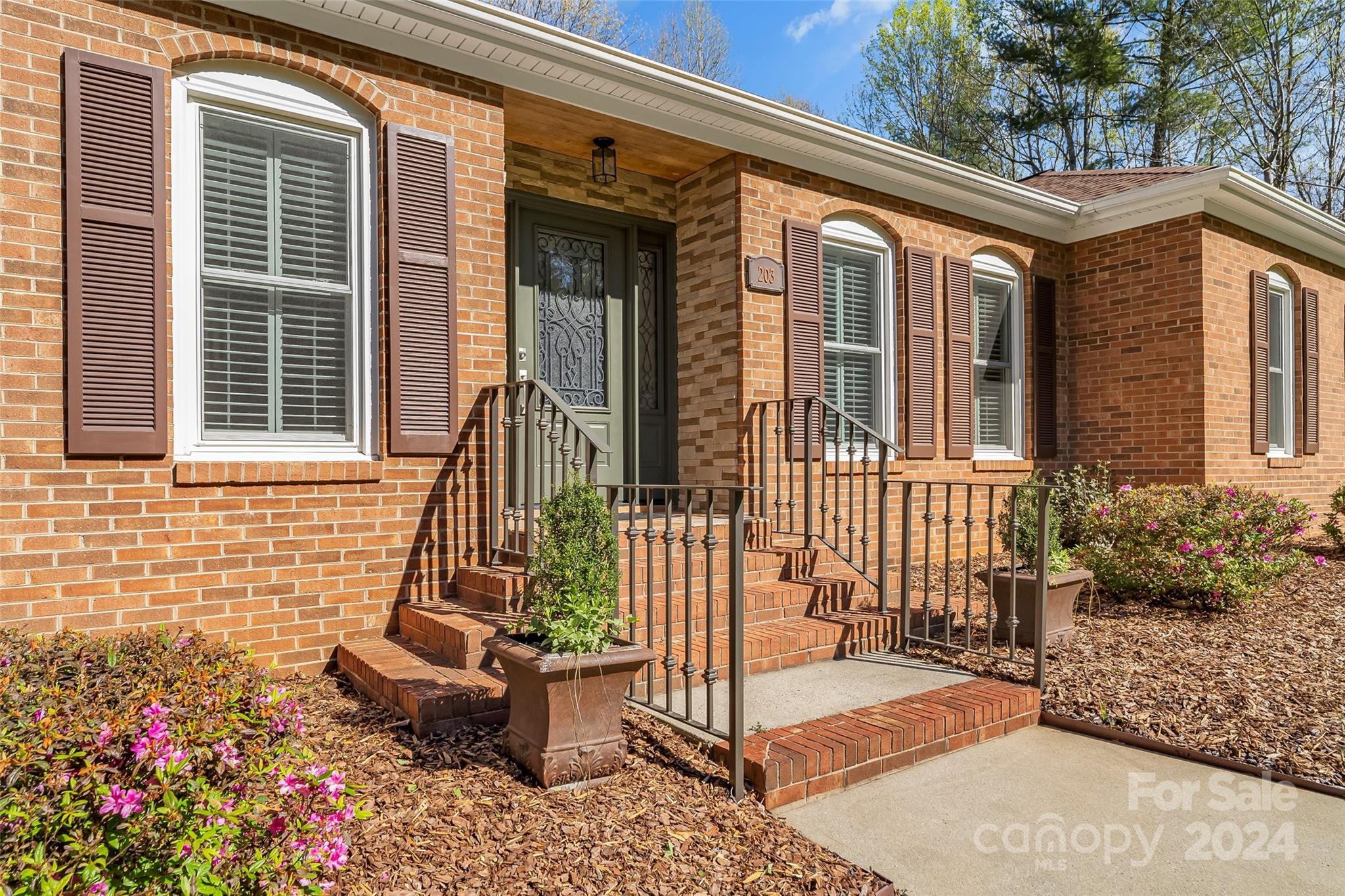 203 Lost Corner Road Morganton, NC 28655 - Photo 5 of 47 a front view of a house with a garden
