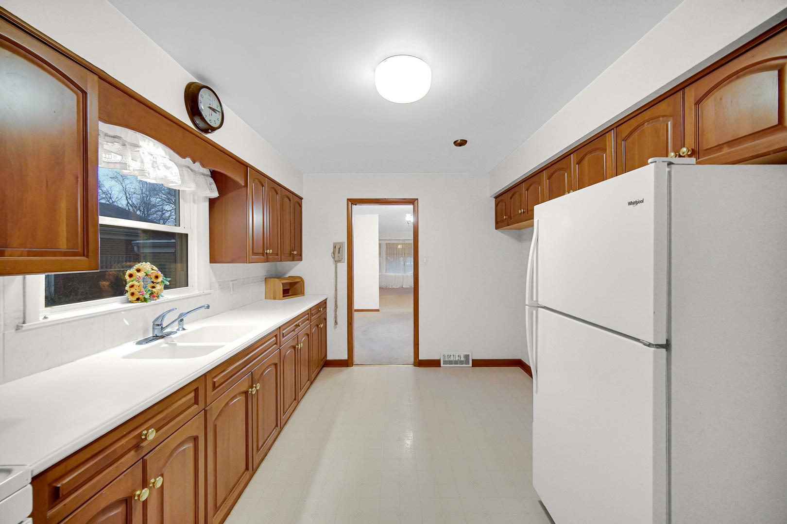 18423 Homewood Avenue Homewood, IL 60430 - Photo 5 of 27 a kitchen with a refrigerator a sink and dishwasher with wooden floor