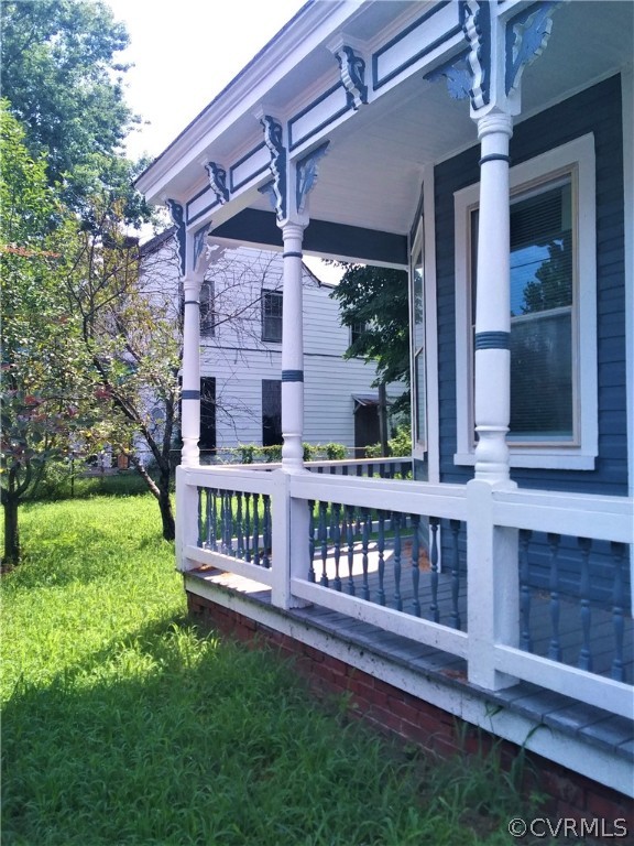 840 Commerce Street Petersburg, VA 23803 - Photo 5 of 38 a view of a house with a wooden deck and a yard