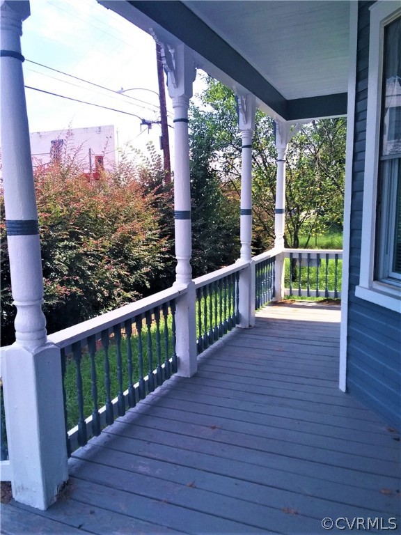 840 Commerce Street Petersburg, VA 23803 - Photo 7 of 38 a view of a porch with wooden floor in front of a house