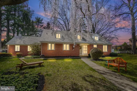 a front view of a house with a yard table and chairs