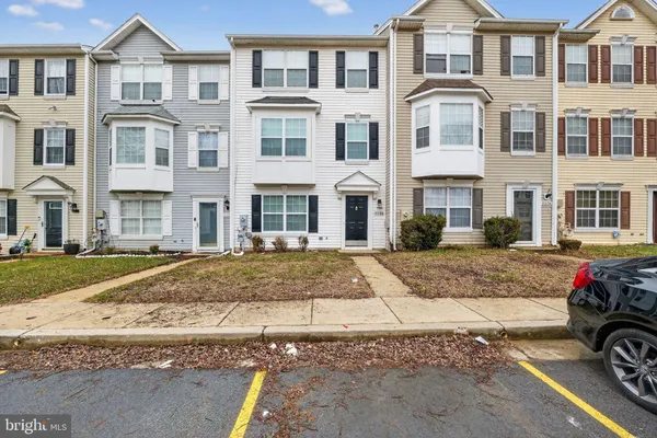 a front view of a residential apartment building with a yard