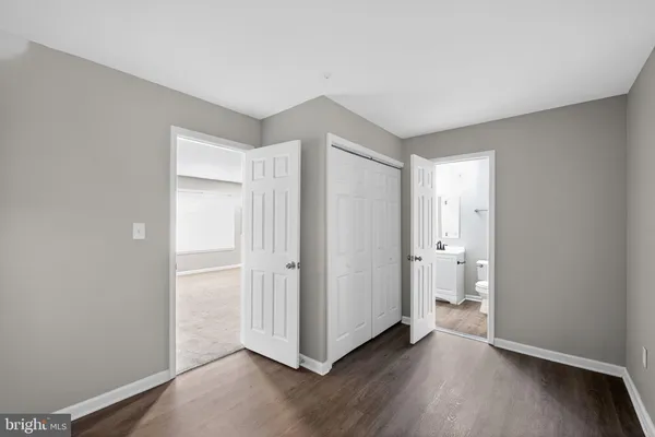 a view of a room with wooden floor