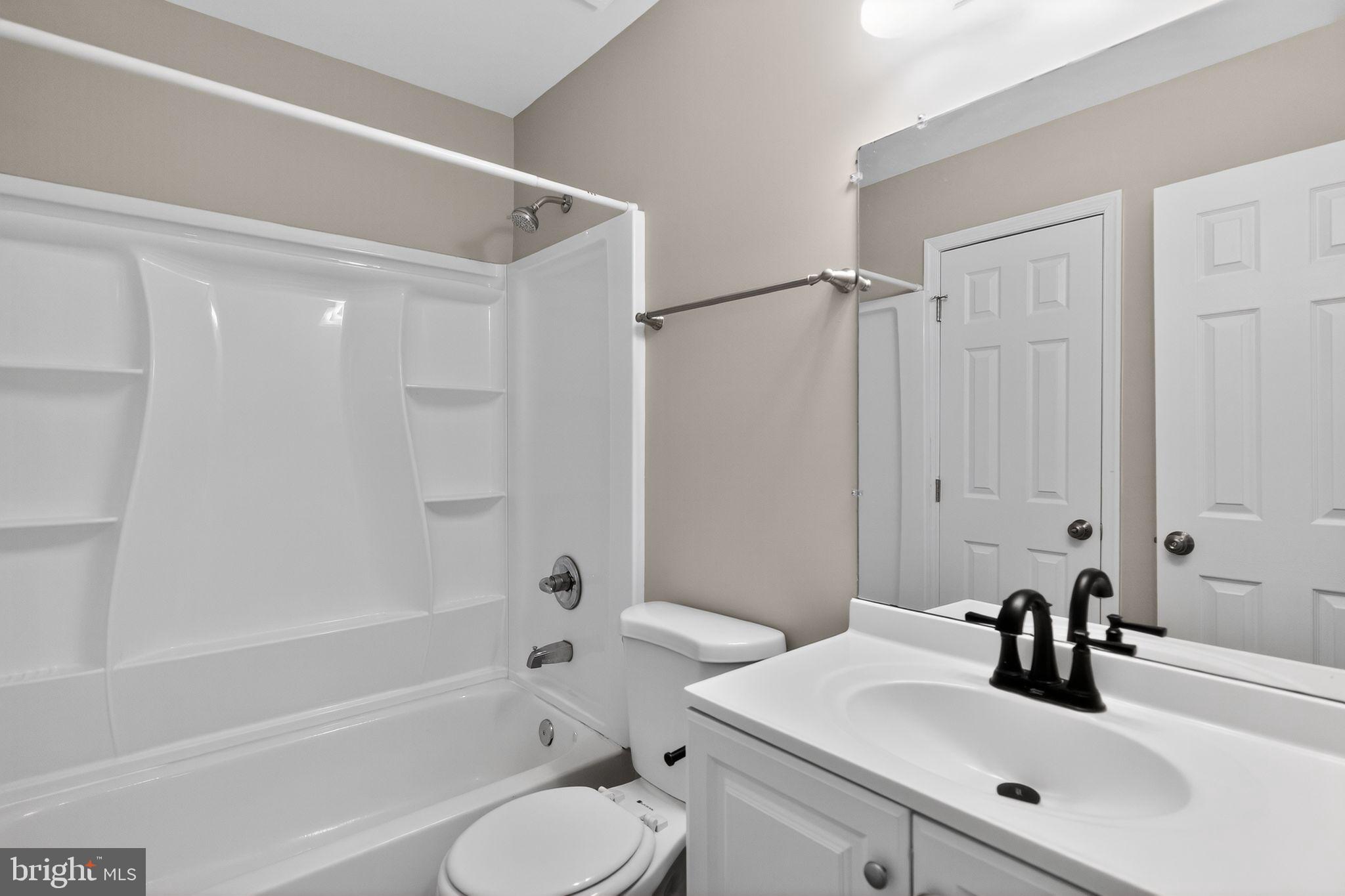 3524 Orchard Shade Road Randallstown, MD 21133 - Photo 18 of 34 a bathroom with a bathtub shower sink vanity mirror and toilet