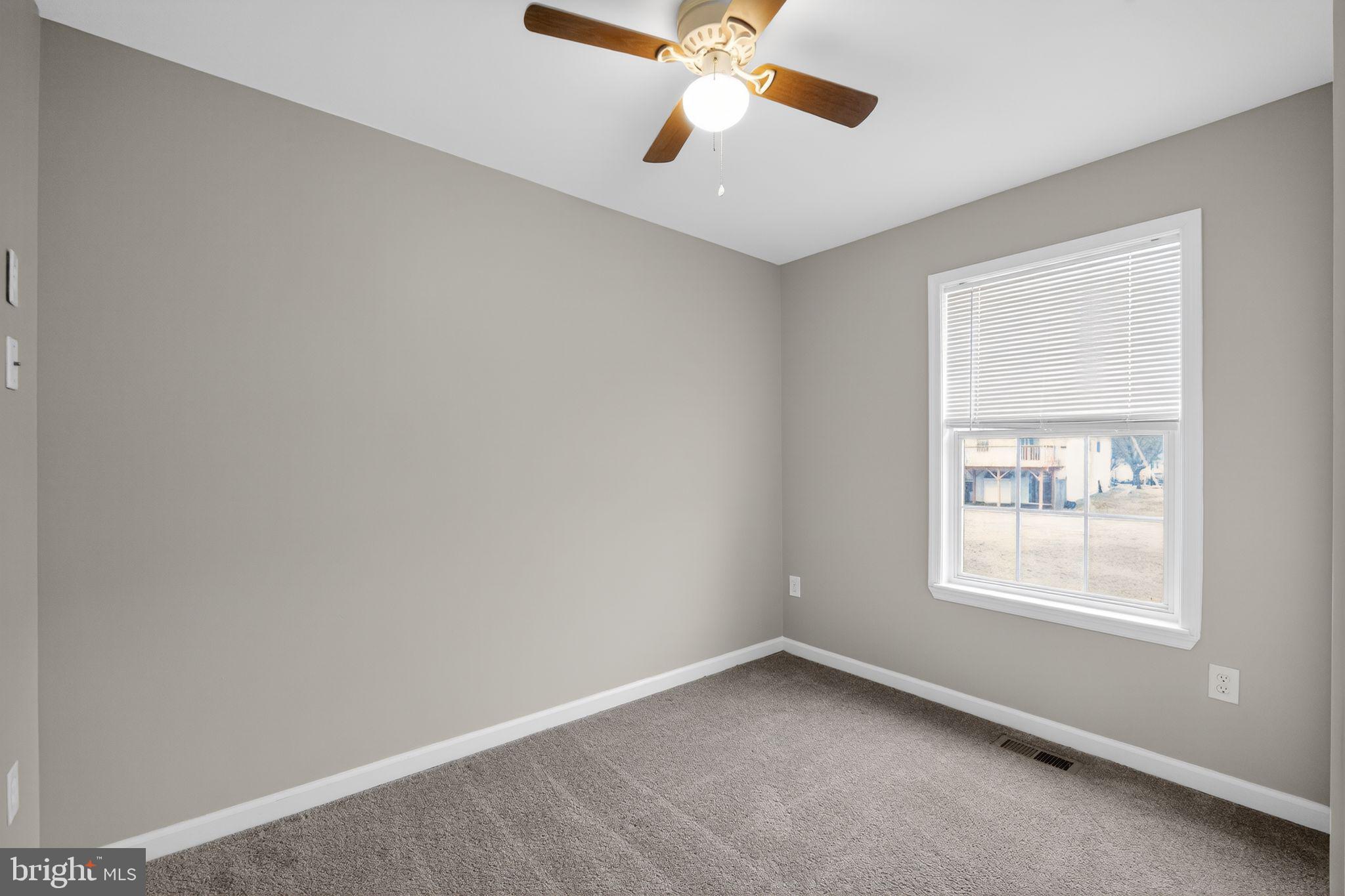 3524 Orchard Shade Road Randallstown, MD 21133 - Photo 22 of 34 an empty room with a window and a fan