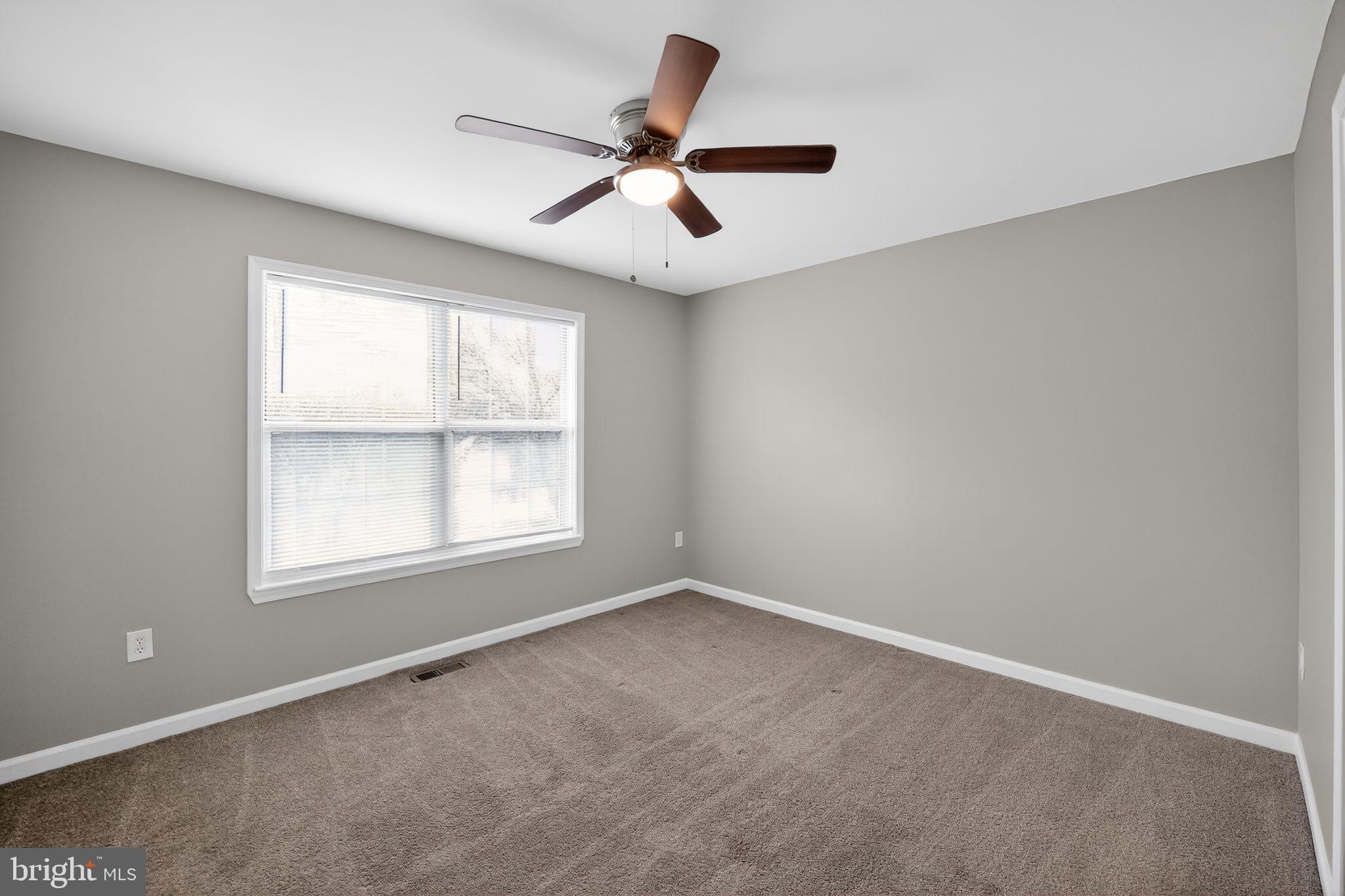 3524 Orchard Shade Road Randallstown, MD 21133 - Photo 23 of 34 an empty room with a window and a fan