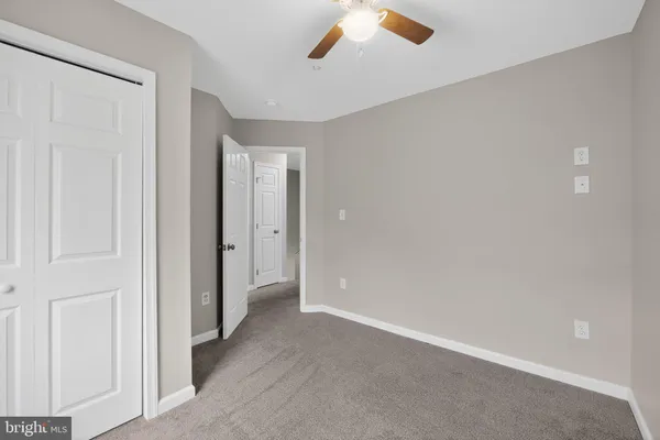 an empty room with windows and closet