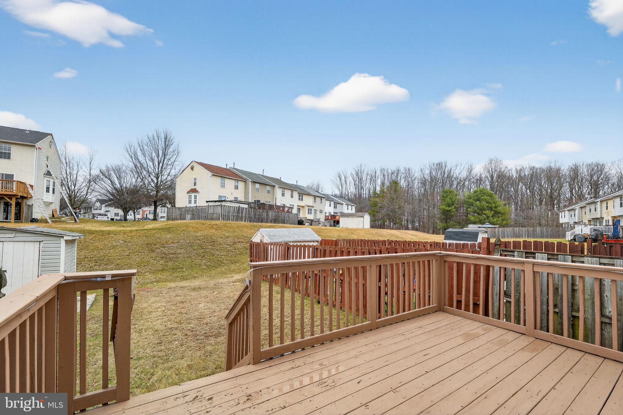 3524 Orchard Shade Road Randallstown, MD 21133 - Photo 33 of 34 a view of wooden deck and lake with trees in the background