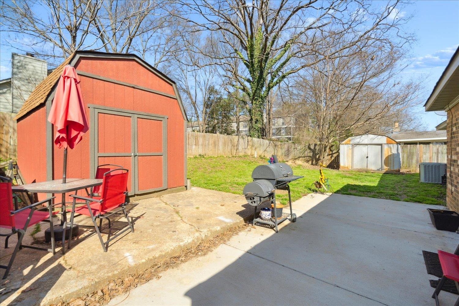 1357 Greenland Road Memphis, TN 38134 - Photo 27 of 29 View of patio featuring central AC, a fenced backyard, an outdoor structure, a grill, and a storage unit