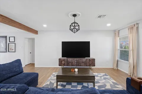 a living room with furniture and a flat screen tv