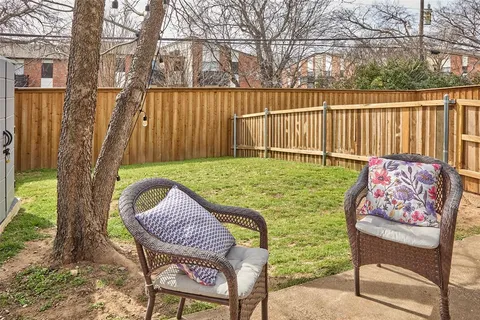 a backyard of a house with table and chairs