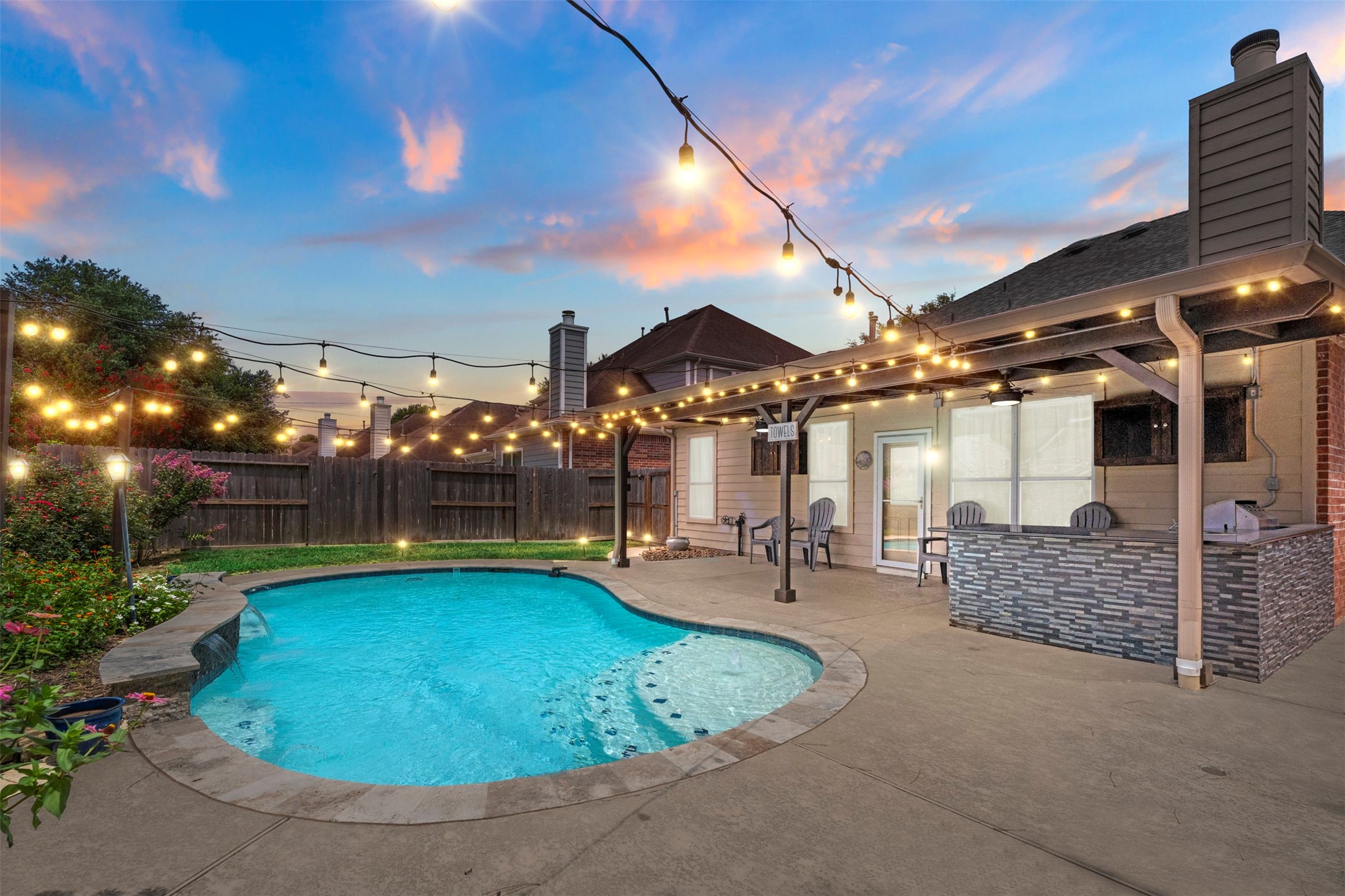 Come beat the summer heat in this sparkling pool with outdoor kitchen.