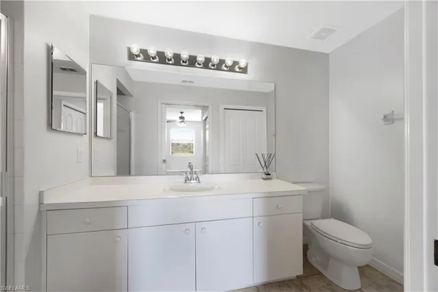 a kitchen with a sink a refrigerator and cabinets