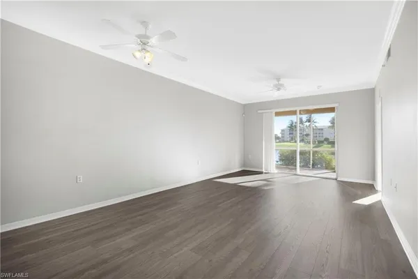 a view of empty room with wooden floor