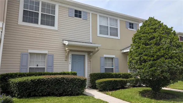 a view of a house with a yard and plants