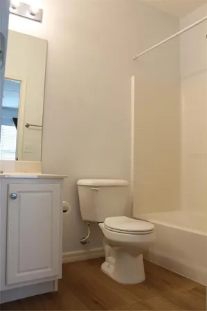 a view of a hallway with closet and wooden floor