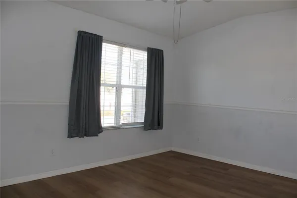 an empty room with wooden floor and closet