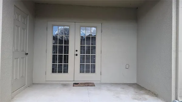a view of a house with pool and sitting area
