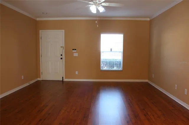 wooden floor in an empty room with a window