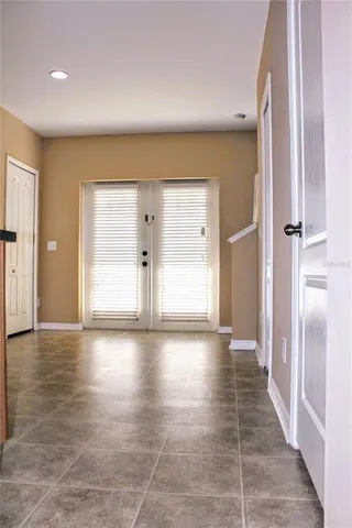 a view of a hallway with wooden floor and closet in a bathroom