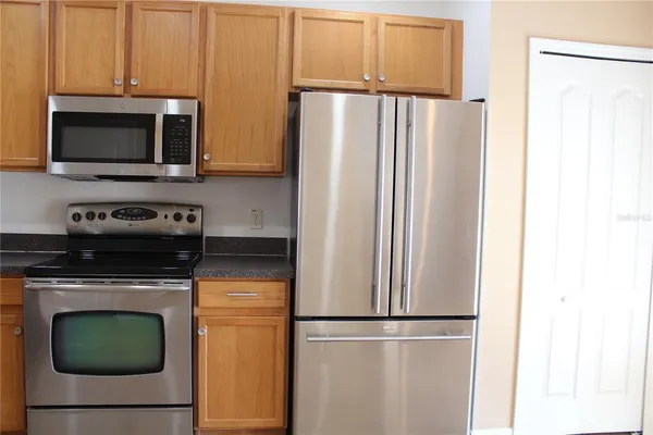 a kitchen with a refrigerator stove and microwave