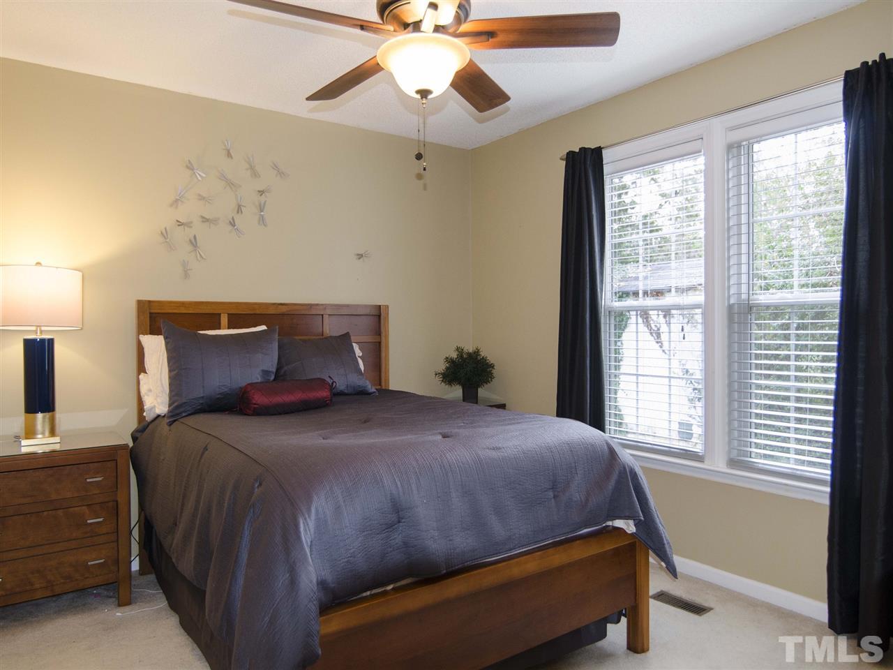 124 Fieldspring Lane Raleigh, NC 27606 - Photo 14 of 24 a bedroom with a bed and window