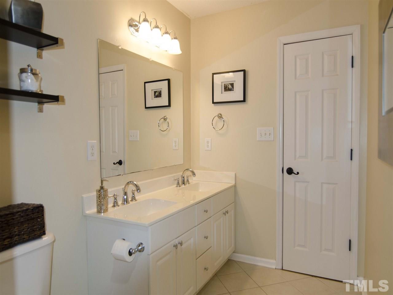 124 Fieldspring Lane Raleigh, NC 27606 - Photo 17 of 24 a bathroom with 2 sink and a mirror