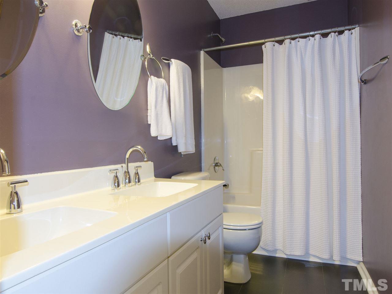 124 Fieldspring Lane Raleigh, NC 27606 - Photo 19 of 24 a bathroom with a sink a toilet and a mirror