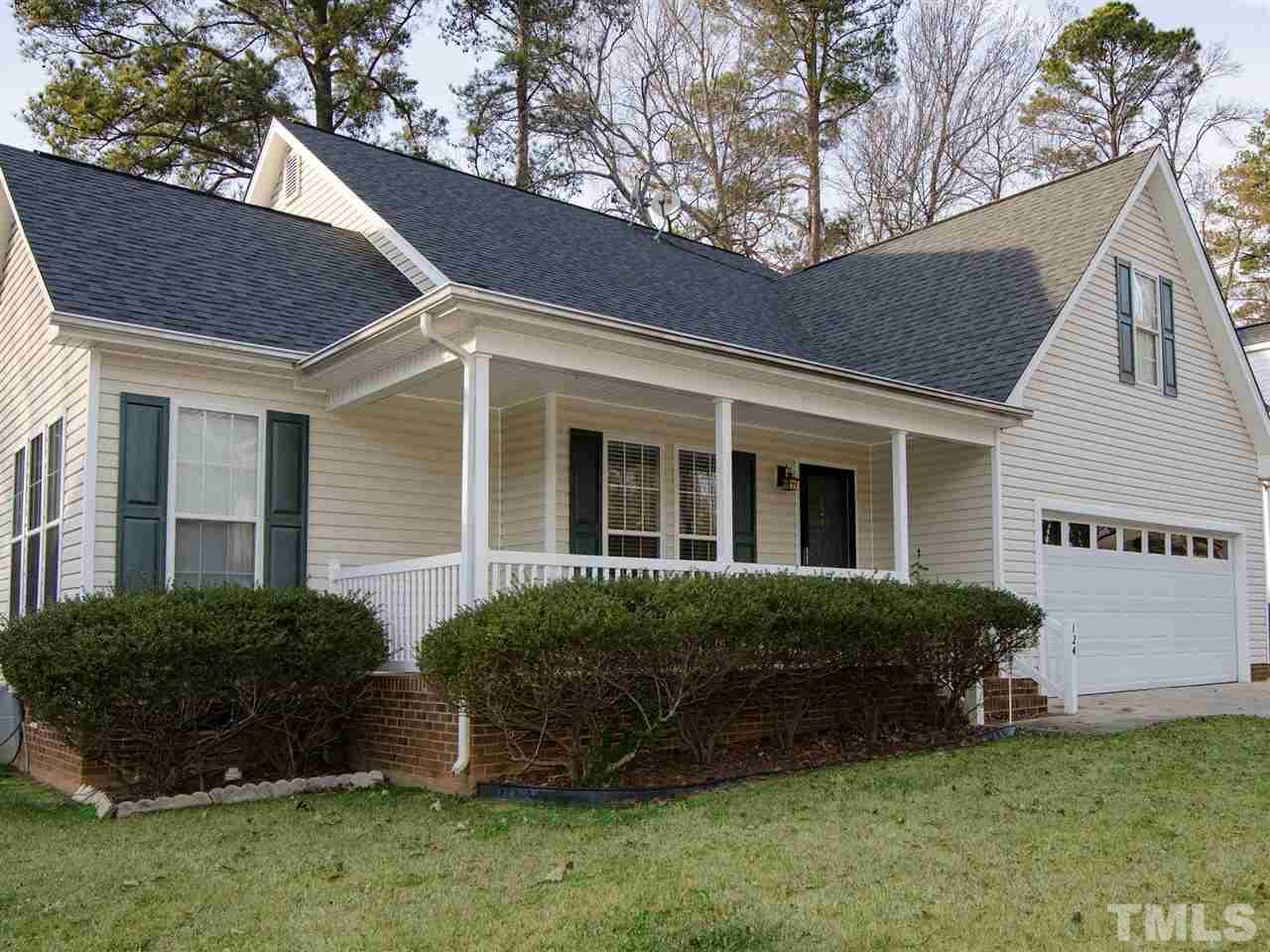 124 Fieldspring Lane Raleigh, NC 27606 - Photo 3 of 24 a view of a house with a yard and a garden