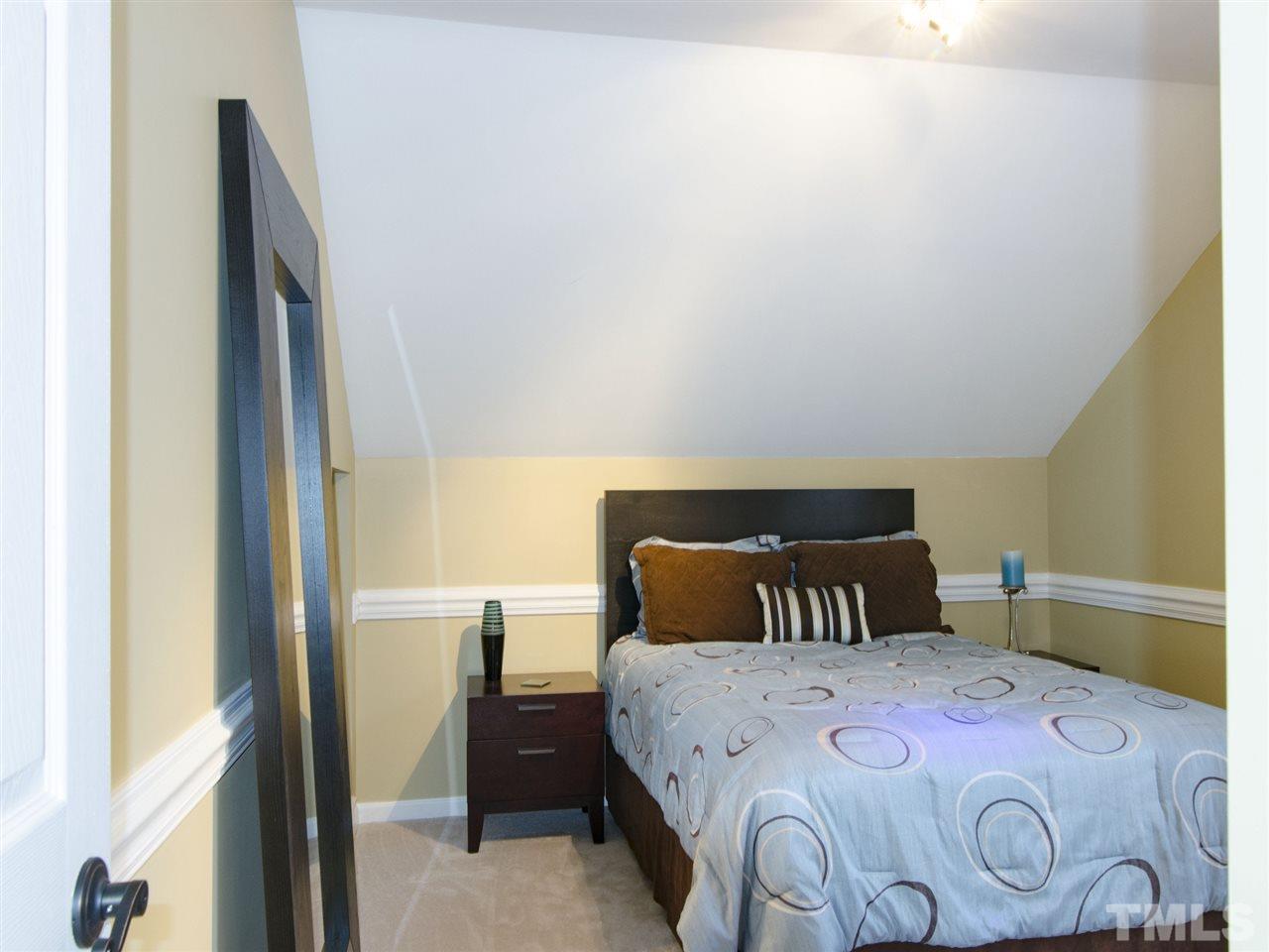 124 Fieldspring Lane Raleigh, NC 27606 - Photo 21 of 24 a bedroom with a bed and wooden floor
