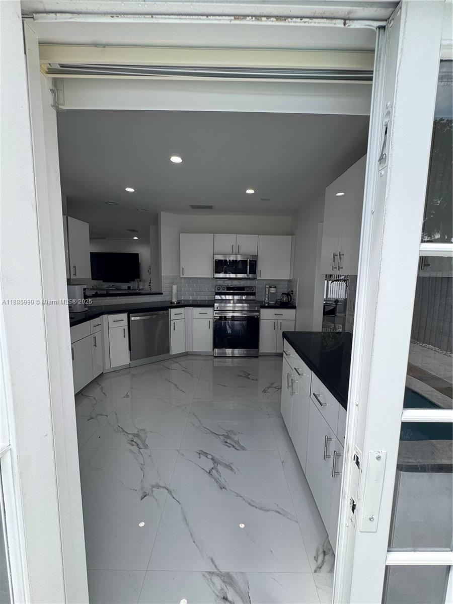11111 Southwest 147th Court Miami, FL 33196 - Photo 13 of 42 a large kitchen with a sink stainless steel appliances and cabinets