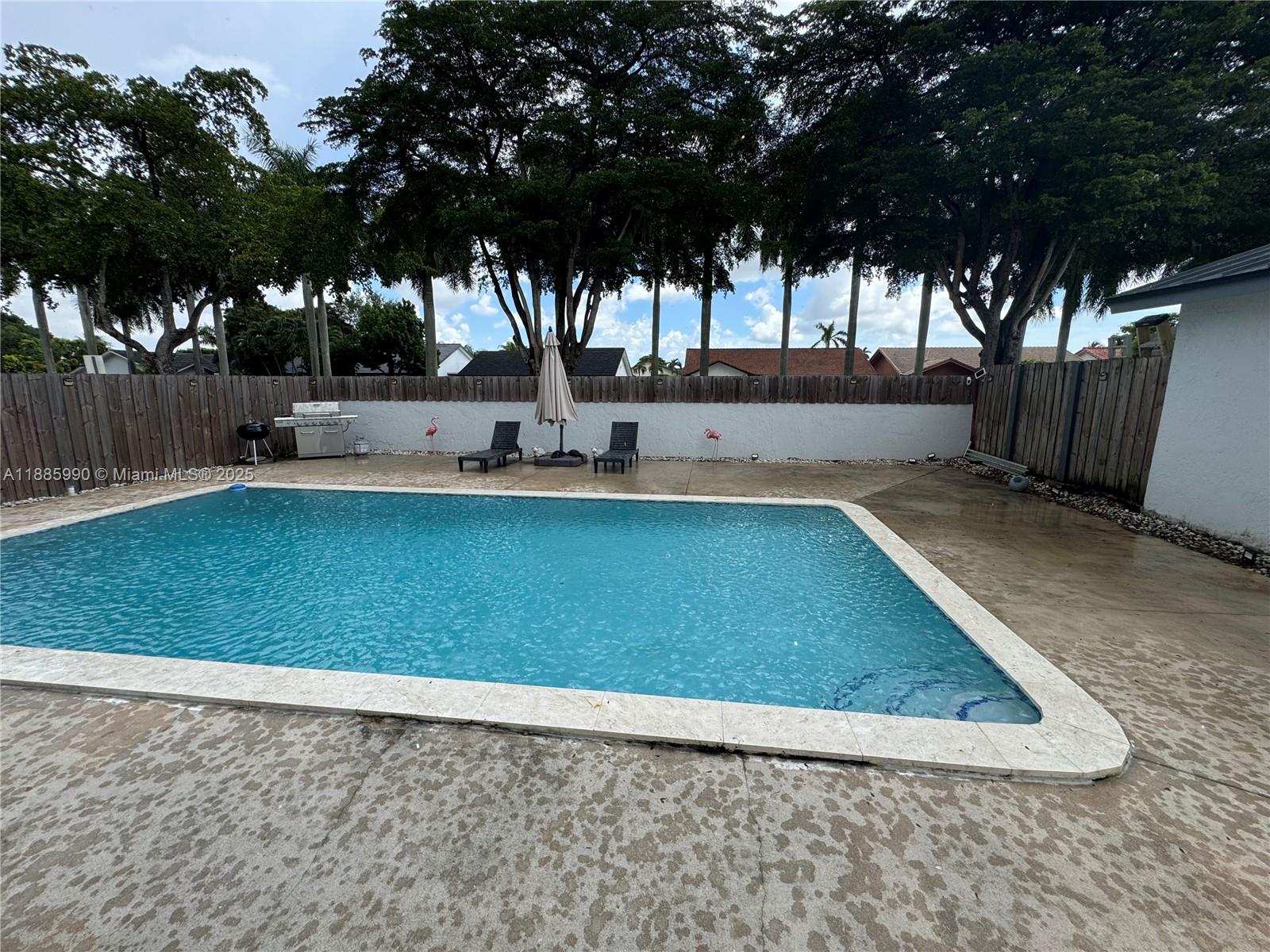 11111 Southwest 147th Court Miami, FL 33196 - Photo 16 of 42 a view of a backyard with large trees and wooden fence