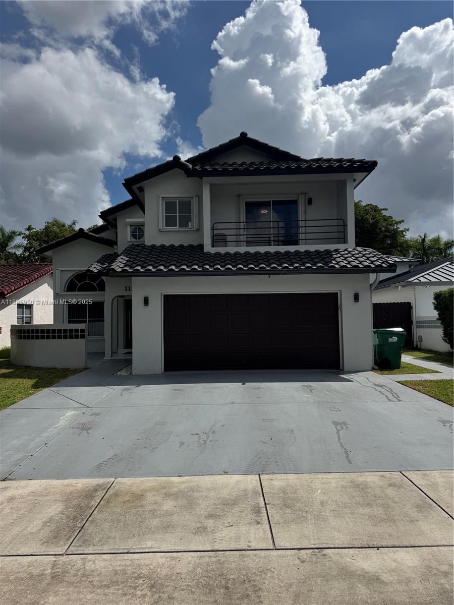 11111 Southwest 147th Court Miami, FL 33196 - Photo 2 of 42 a front view of a house with a garden