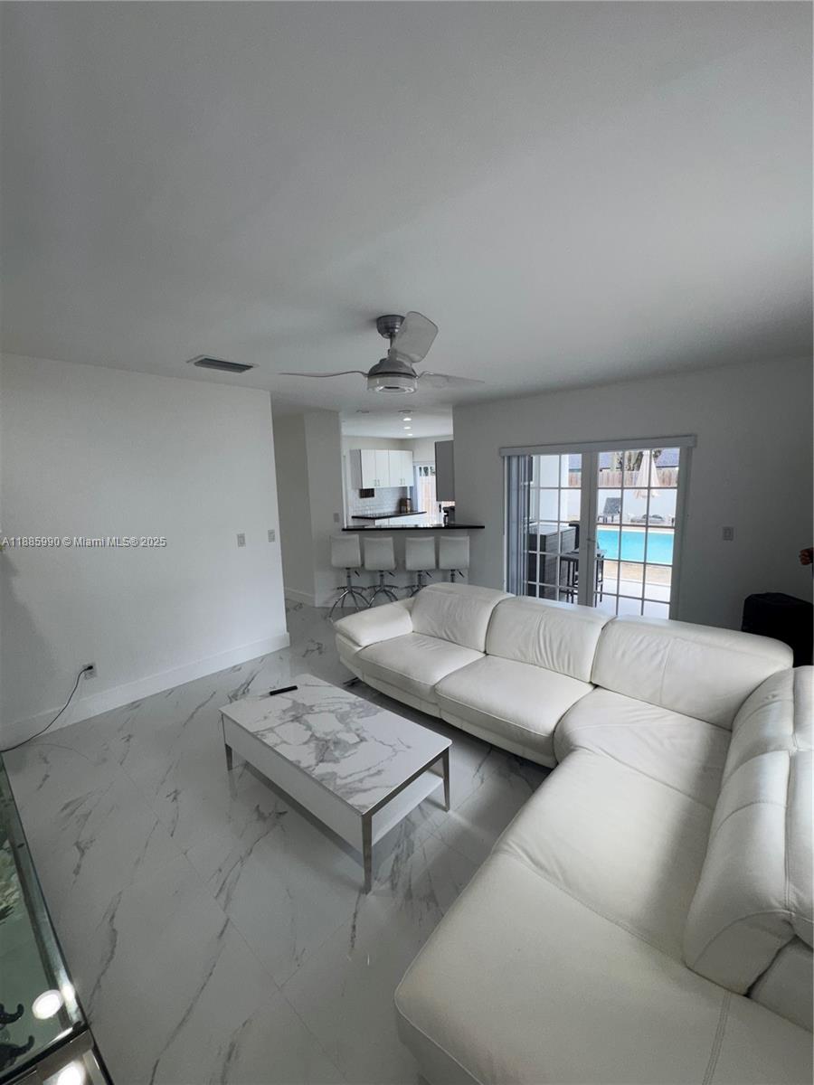 11111 Southwest 147th Court Miami, FL 33196 - Photo 22 of 42 a living room with furniture and a wooden floor