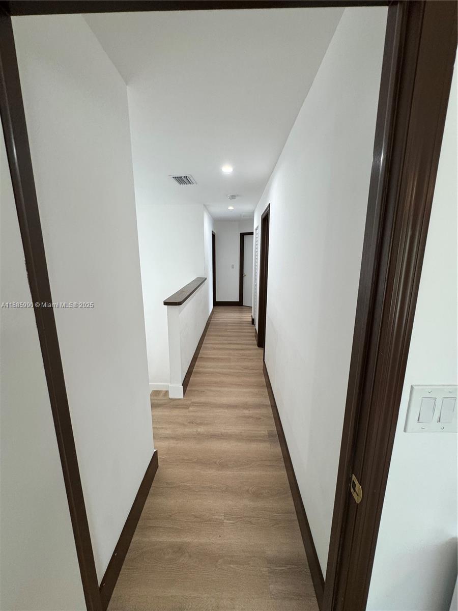 11111 Southwest 147th Court Miami, FL 33196 - Photo 32 of 42 a view of a hallway with wooden floor and staircase