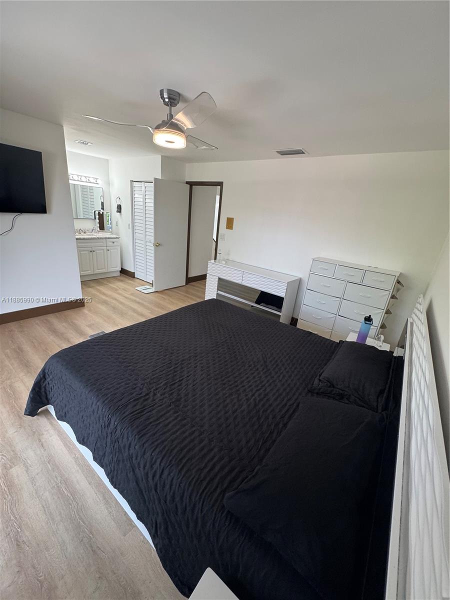 11111 Southwest 147th Court Miami, FL 33196 - Photo 34 of 42 a bedroom with a bed and a tv