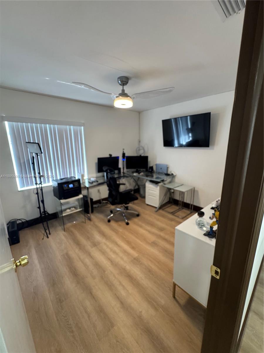 11111 Southwest 147th Court Miami, FL 33196 - Photo 38 of 42 a living room with furniture and a flat screen tv