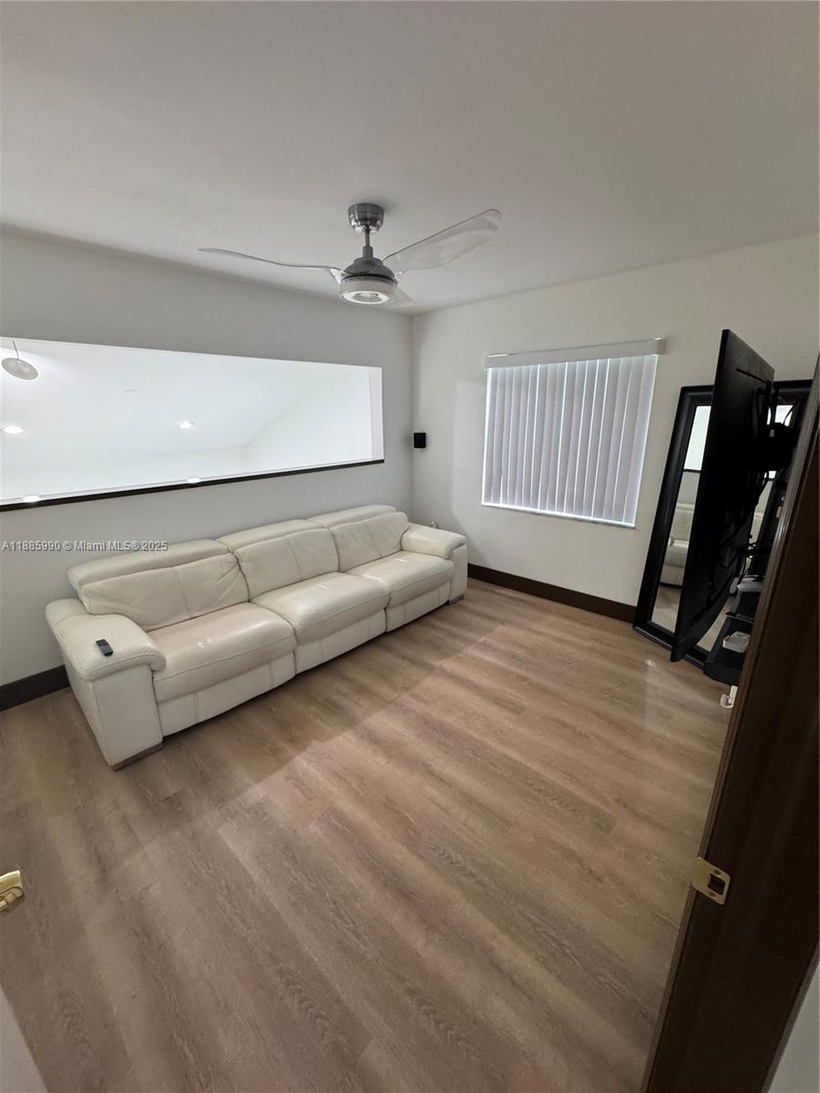 11111 Southwest 147th Court Miami, FL 33196 - Photo 40 of 42 a living room with furniture and a wooden floor