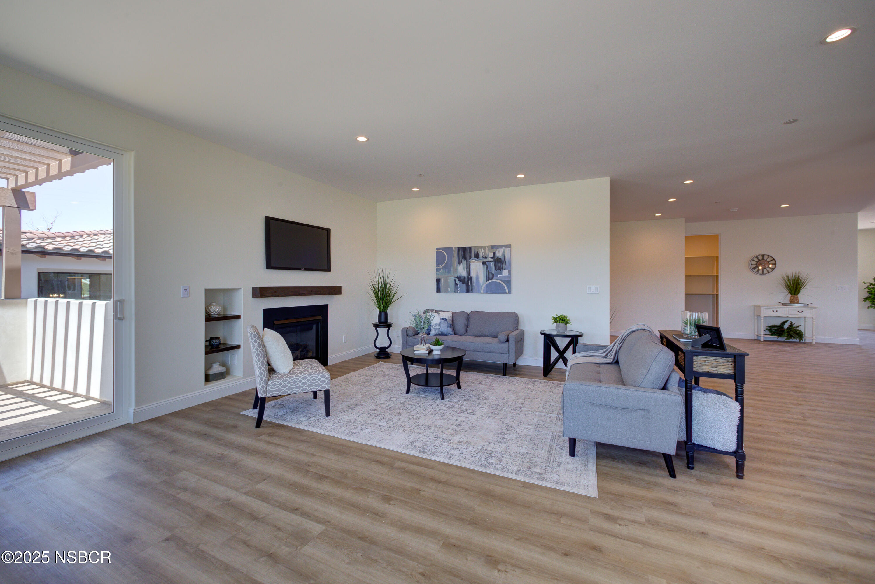 1607 Tuscan Way Santa Maria, CA 93455 - Photo 11 of 37 a living room with furniture a fireplace and a flat screen tv